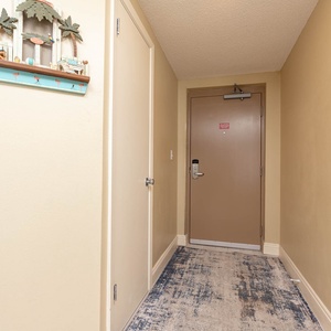 Step into a welcoming hallway adorned with charming decor and a cozy rug, setting the tone for your beach stay