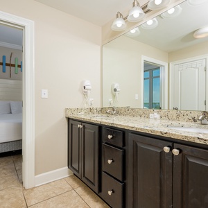 Experience this refreshing guest bath featuring a spacious granite countertop and a dual vanity