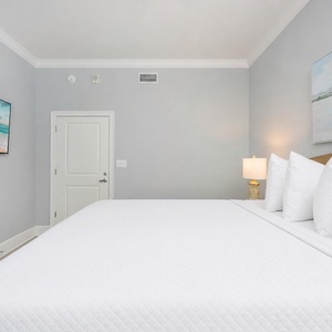Unwind in this guest bedroom featuring a cozy king bed, soft lighting, and a TV for your favorite shows