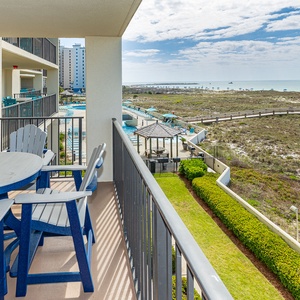 Balcony seating offers a tranquil view of the beach and gentle waves, perfect for enjoying the coastal breeze