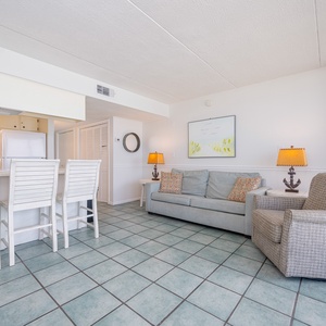 Unwind in the cozy living area, basking in gentle natural light and savoring conversation with loved ones