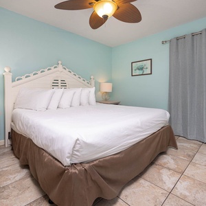 Tranquil bedroom featuring a king bed, soft linens, and soothing blue walls for a restful stay