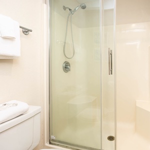 Refresh in the master shower area featuring a walk-in design and plush towels for your comfort