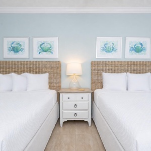 Relax in this guest suite with two queen beds and wake to a fun day at the beach