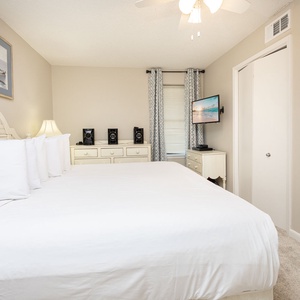 Comfortable master suite bedroom featuring a king bed, soft carpet, and a TV for your entertainment