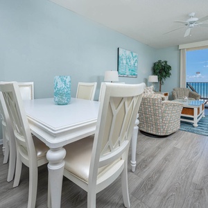 Brightly colored chairs complement the dining area, offering a relaxed vibe with stunning views of the beach