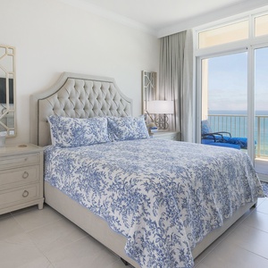 Retreat to the elegant king master suite with plush bedding and beachfront balcony access