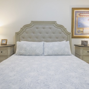 Stretch out on the king bed beneath the tufted headboard and read by the warm bedside lamps