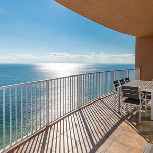 Enjoy meals or morning coffee on the spacious balcony, offering expansive beachfront views