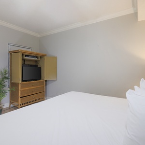 Drift into peaceful relaxation on the soft king bed, with soothing ambiance inviting restful slumber