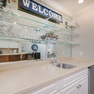 Mix refreshing drinks at the wet bar, savoring the inviting vibe as you prepare for beachside fun