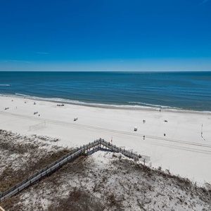 View of the serene beach and tranquil waters from a high vantage point, perfect for a relaxing getaway