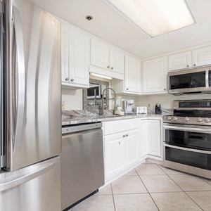 Cook and gather in this stylish kitchen featuring stainless appliances and elegant countertops