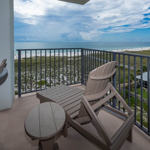 Relax on the balcony with comfortable seating, overlooking the beach and the tranquil gulf waters beyond