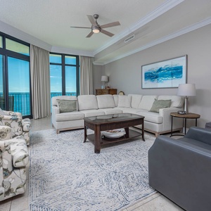 Relax in the inviting living room, where large windows frame coastal views and cozy seating beckons family gatherings