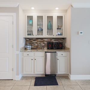 Sip refreshing beverages and entertain from this stylish wet bar with elegant glassware display and stereo system