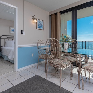 Enjoy dining at the glass table with stunning beachfront views and a cozy atmosphere from this inviting space