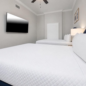 Enjoy restful nights on two beds and stream your favorite show in this queen guest suite