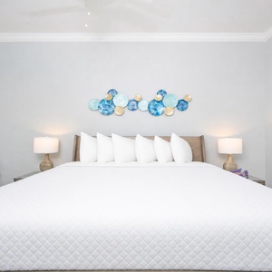 Cheerful king suite featuring a plush bed, decorative wall art, and soft lighting for a restful stay