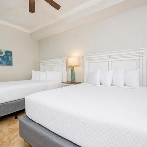 Experience restful nights in this queen guest suite, where fluffy bedding invites relaxation after your beach adventures