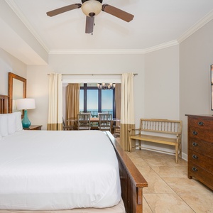 Relaxing master bedroom featuring a king bed, large TV, and a stunning view