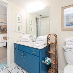 Refresh yourself in the bathroom, surrounded by fluffy towels and coastal decor, inviting relaxation