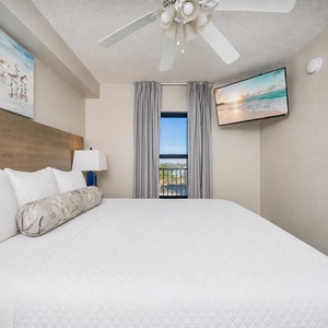 Fluffy pillows invite you to relax in the king suite for a calm movie night after a fun day at the beach
