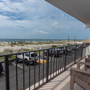 Enjoy the beachfront view from the balcony, complete with comfortable seating for relaxation and sunbathing