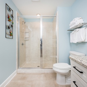 Experience a refreshing shower in this guest bathroom with soft towels