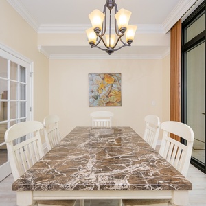 Bright dining area featuring a marble table and a view of the balcony, perfect for enjoying meals with a scenic backdrop