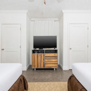 Relax in this inviting guest room with two comfortable double beds, a large TV, and easy access to the bathroom
