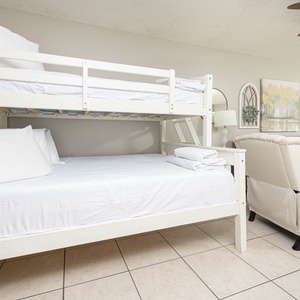 Twin over full bunk bed nook in the living area, featuring fresh linens and a stylish design
