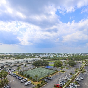 Take in the expansive view from the master balcony, showcasing green spaces, tennis courts, and a vibrant community below