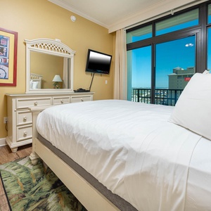 Rest easy in this cozy queen guest suite where vibrant decor complements beautiful views, inviting peaceful nights