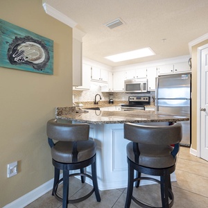 Gather around the sleek granite counter with comfortable seating, perfect for casual meals and conversations