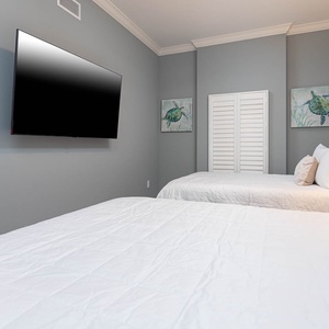 Watch shows on the wall TV from soft queen beds, admire turtle art, and unwind after a beach day