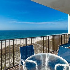 Blue sky stretches endlessly above the shore as you relax on your balcony and watch the waves roll in