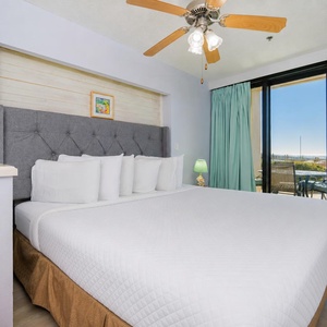 Plush king bed in your suite invites restful nights before waking to tranquil views from your patio
