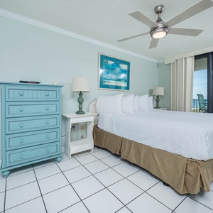 Inviting master bedroom featuring a plush king bed, colorful decor, and stunning beach views