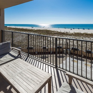 Relax on the comfortable seating of your balcony while enjoying the expansive view of the beach and sparkling water