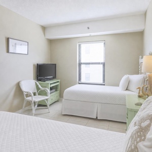 Relax after a day at the beach in this guest room with two cozy twin beds