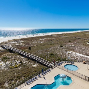Breathtaking views of the beach stretch out alongside the inviting pool area, perfect for relaxation and sun-filled days