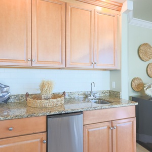 Enjoy beverages from the elegant wet bar, soaking in the beach vibe as you relax with family