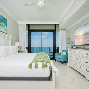 Unwind in this inviting bedroom after a beach day with your favorite show and beachfront balcony access