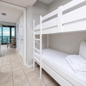 Discover the cozy bunk area, perfect for kids, with fresh linens and easy access to the living area