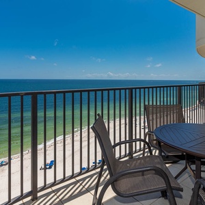 Breathe in the fresh air while enjoying meals at the balcony table with expansive views of the tranquil shoreline