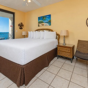 Experience restful nights in this inviting master bedroom with a king bed and easy access to a balcony with beach views