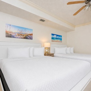 Drift into restful slumber on the plush queen beds, embraced by soft linens and coastal decor for a peaceful retreat