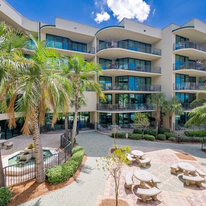 Embrace sunny days from your balcony, surrounded by swaying palms and the soothing sounds of the pool below