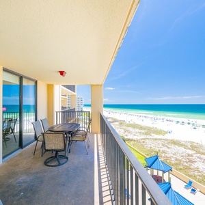Large patio with table and chairs for relaxing after a long day at the beach